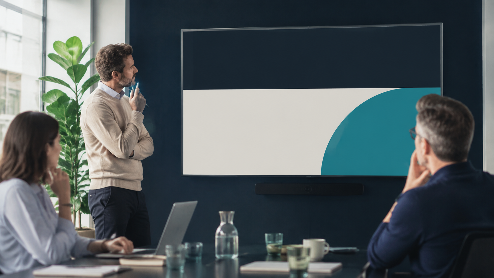 Presenter considering the headline area of a slide during a team meeting