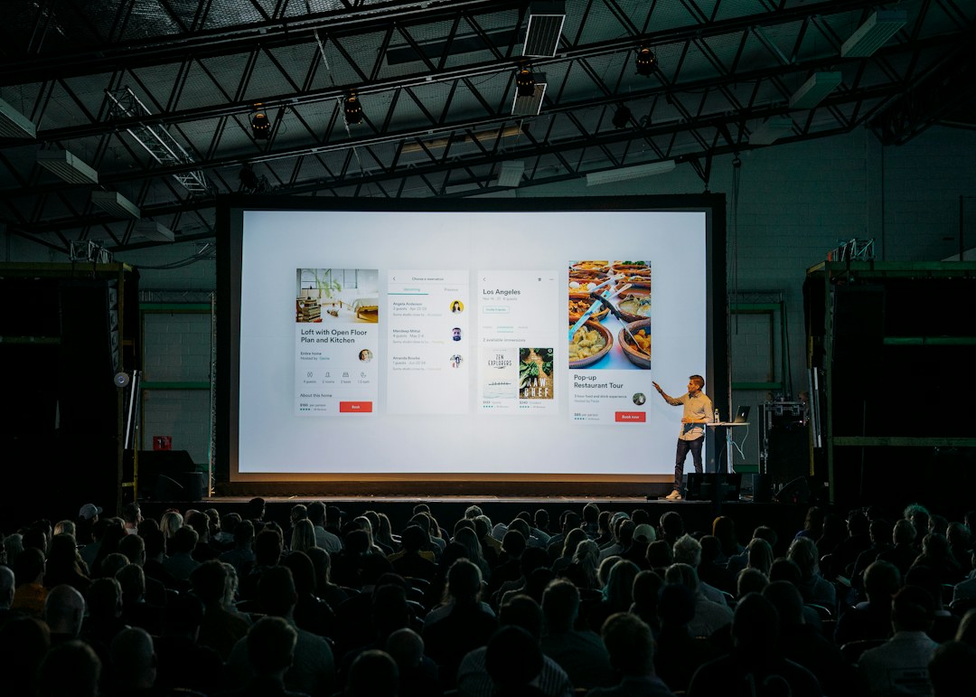 Presenter speaking to a mixed-expertise audience during a professional presentation
