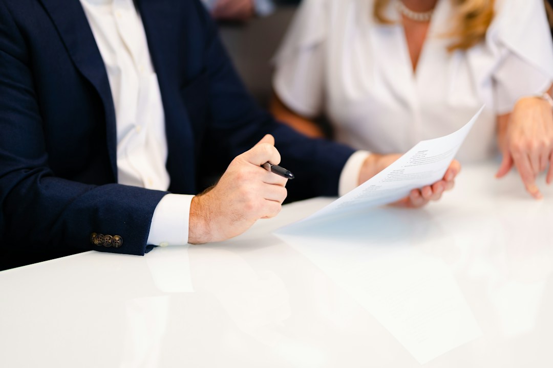Two people reviewing printed presentation material at a table